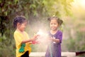 Two asian little girls having fun to play water together Royalty Free Stock Photo