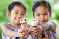 Two asian little girls holding delicious ice cream waffle cone Royalty Free Stock Photo