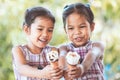 Two asian little girls holding delicious ice cream waffle cone