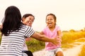 Two asian little girls running to their mother to give a hug Royalty Free Stock Photo