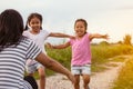 Two asian little girls running to their mother to give a hug Royalty Free Stock Photo