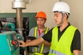 Two asian maintenance technician checking technical data of water pressure control system equipment in factory Royalty Free Stock Photo