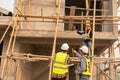 Two Asian male engineers shaking hands and working together Hope stands on the architectural construction Royalty Free Stock Photo