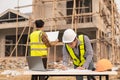 Two Asian male engineers shaking hands and working together Hope stands on the architectural construction Royalty Free Stock Photo
