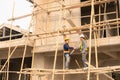 Two Asian male engineers shaking hands and working together Hope stands on the architectural construction Royalty Free Stock Photo