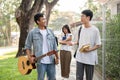 Two Asian male student friends are enjoying talking while walking on a footpath on their campus Royalty Free Stock Photo