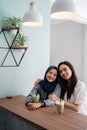 Asian muslim woman bestfriend together in cafe