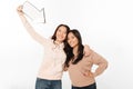 Two asian positive ladies sisters holding arrow.