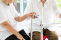 Two asian senior women friends holding hands for care,help and support her friend,time together,old people with walker during Royalty Free Stock Photo