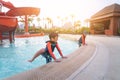 Asian siblings in playing together in Water Aqua park pool