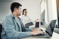 Two asian team working development of programming and encryption technology website design programmers on desk in office