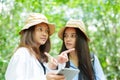 Two Asian teenage girls are best friends, another friend is holding tablet in hand look at walking directions, walking maps in Royalty Free Stock Photo