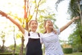 two asian teenager laughing with happiness emotion in green natural park