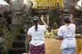 Two Asian woman praying in temple