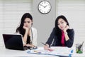 Two asian woman tired in office