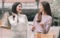 Two asian women doing window shopping together