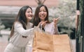 Two asian women doing window shopping together