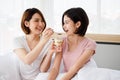 Two Asian women feeding food to each other. Royalty Free Stock Photo