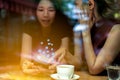 Two Asian women,friends having a free time drinking coffee at cafe. Friends laughing together while drinking a coffee in the