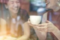 Two Asian women,friends having a free time drinking coffee at cafe. Friends laughing together while drinking a coffee in the resta