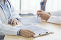 Two asian women hand doctors meeting write prescription medical clinic. Doctor discuss using laptop write note. Close up hands of