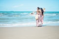 Two Asian women jogging on the beach in the morning. Rest time and holidays Royalty Free Stock Photo