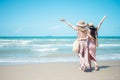 Two Asian women jogging on the beach in the morning. Rest time and holidays Royalty Free Stock Photo