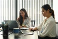 Two women office workers working together in office. Royalty Free Stock Photo
