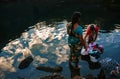 Two asian women washing clothes in a pond Royalty Free Stock Photo