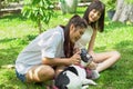 two asian young beautiful woman playing with french bulldog puppy in park outdoor Royalty Free Stock Photo