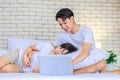 Two Asian young cheerful happy teenager gay men lover partner boyfriend couple sitting smiling lying down cuddling hugging Royalty Free Stock Photo