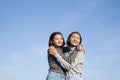 Two Asian young girl standing at the field grass with blue sky Royalty Free Stock Photo