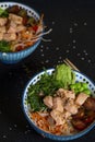 Two assorted bowls with salmon, vegetables, and rice. Hawaiian Poke cuisine