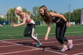 Two athlete young woman runnner at the stadium