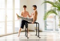 Two athletic men working out doing calisthenics