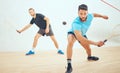 Two athletic squash players playing match during competitive court game. Fit active mixed race and caucasian athlete Royalty Free Stock Photo