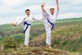 Two athletic women in martial arts tunics