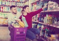 Two attentive adult people in good spirits selecting detergents Royalty Free Stock Photo