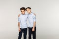 Two attractive boys teenagers in blue shirts