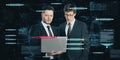 Two attractive european businessmen using laptop with abstract glowing big data blockchain interface on dark background.