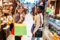 Two attractive females in food-court, shopping