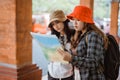two attractive girls chat while looking at a map