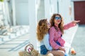 Two attractive girls, cheerful best friends having fun at beach party. Wearing summer outfit, shorts and t-shirts,having Royalty Free Stock Photo