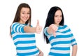 Two attractive girls show thumbs