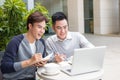 Two attractive mature students talking and working outdoors on l Royalty Free Stock Photo