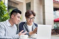 Two attractive mature students talking and working outdoors on l Royalty Free Stock Photo