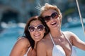 Two attractive smiling woman on sailboat