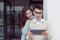 Two attractive students learning and looking in tablet pc at campus outdoor Royalty Free Stock Photo