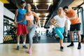 Two attractive women exercising with personal trainers