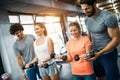 Two attractive women exercising with personal trainers